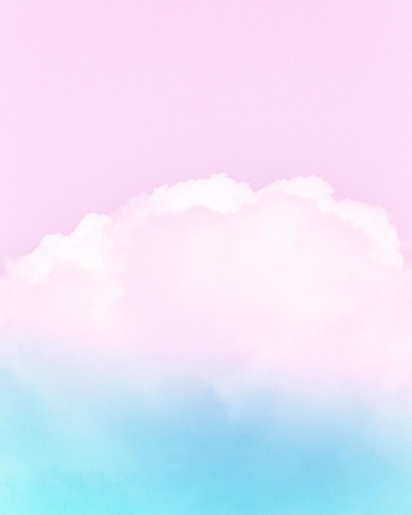 Soft pastel clouds against a pink and blue sky, perfect for serene backgrounds.